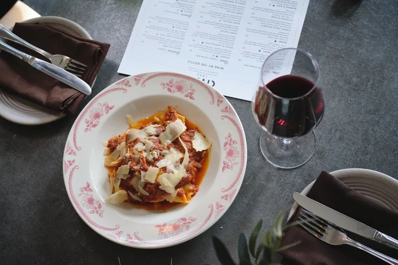 Wide pasta ribbons with sauce and shaved cheese at Civico 1845